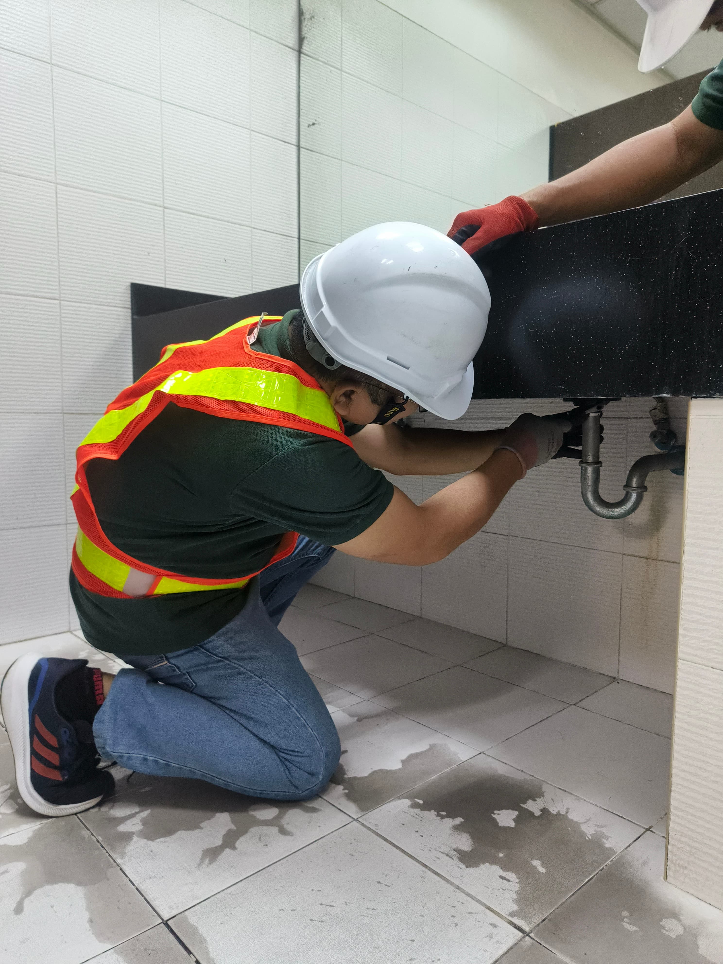 Plumbing crew servicing water lines and fixtures